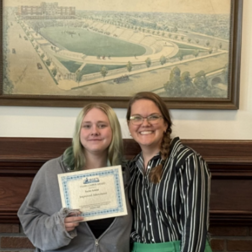 Taylor Askins, Collegiate's Stairclimber for November, poses with his award plaque.